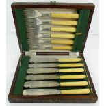 A set of twelve Victorian silver fish knives and forks, each with ivory handle,