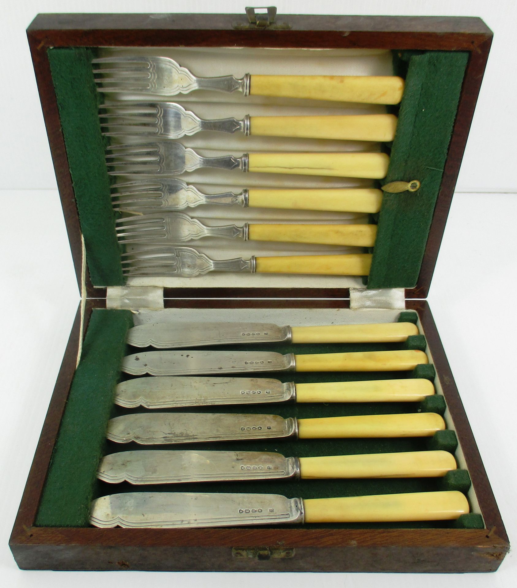 A set of twelve Victorian silver fish knives and forks, each with ivory handle,