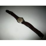 A gents Omega wristwatch with stainless steel case and maroon leather strap Further