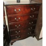 A reproduction mahogany serpentine front 5 drawer chest of drawers