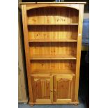 A pine 3 shelf bookcase/wall unit with 2 under doors 93 x 185cm high