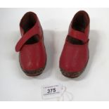 A pair of miniature clogs in red