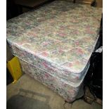 A green and pink floral patterned double bed and mattress