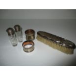 A silver napkin ring, two silver topped scent bottles,