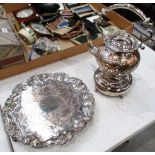 A circular silver plated tray with fruit and vine decoration,