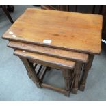 An oak finish nest of 3 coffee tables