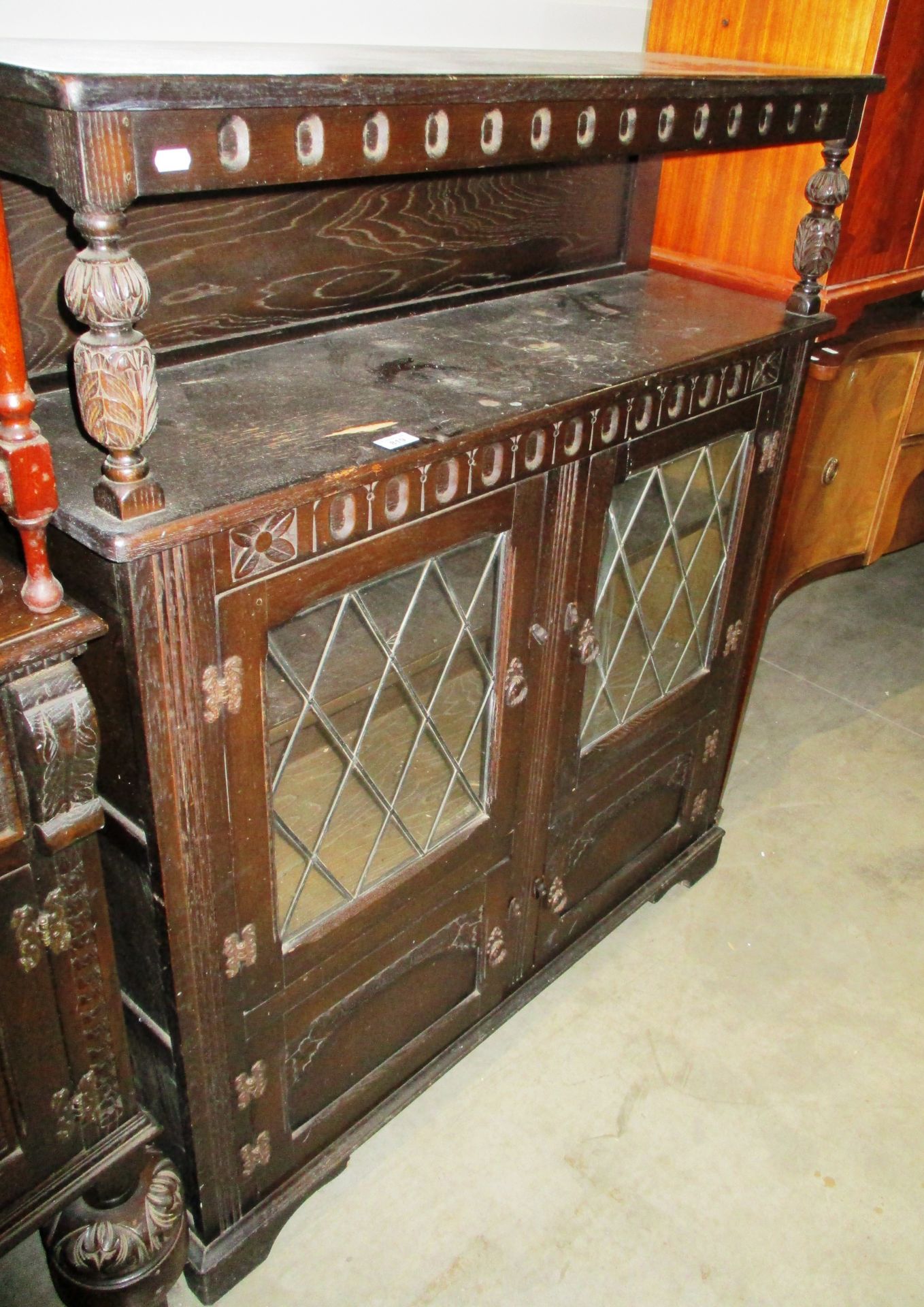An oak side cabinet with 2 leaded glazed doors over 2 small doors 110cm