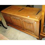 An oak blanket box with linen fold panels