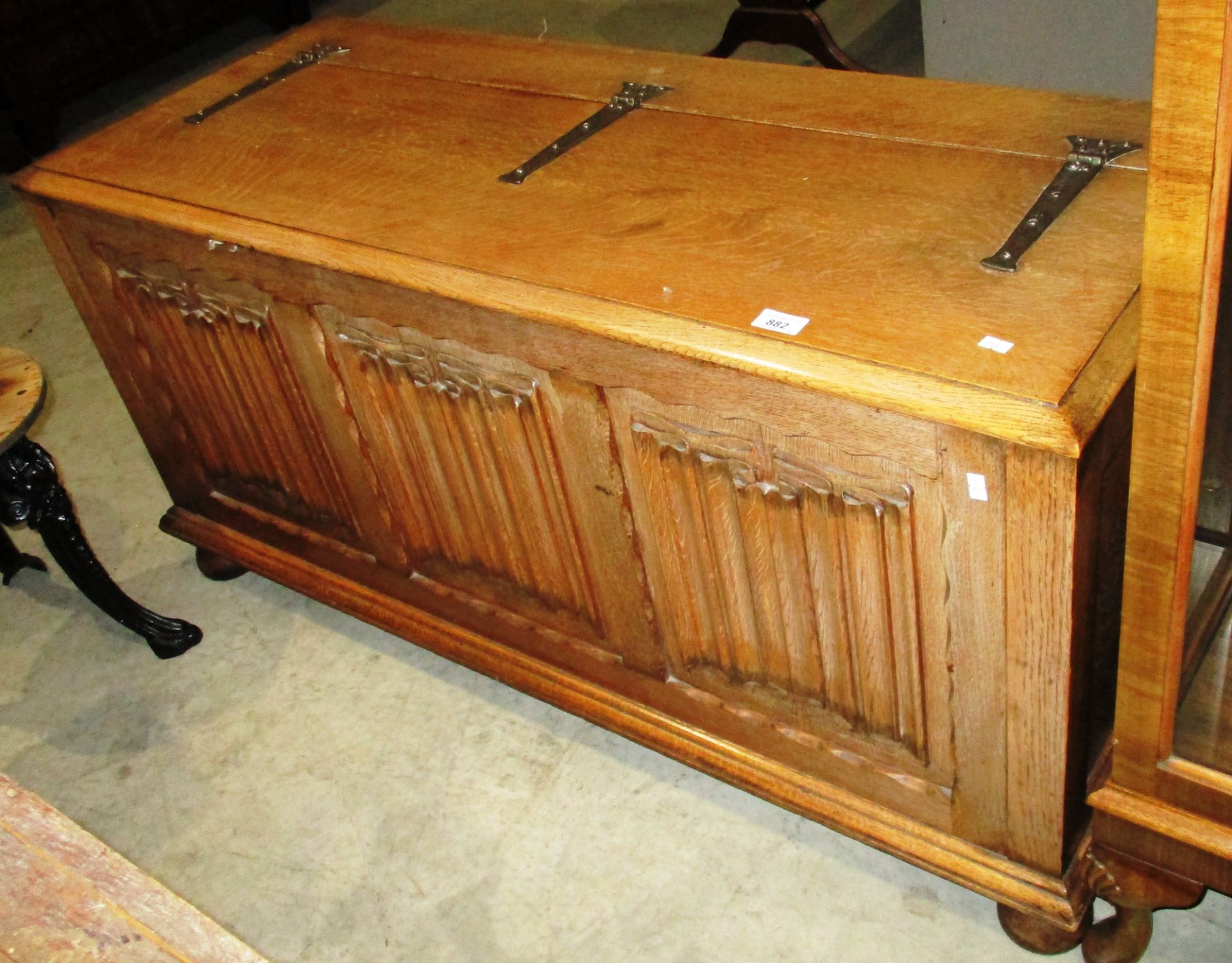 An oak blanket box with linen fold panels