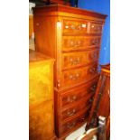 A reproduction serpentine front walnut 8 drawer chest of drawers (2 short,