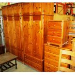 A pine 4 piece bedroom suite comprising triple door wardrobe with top box 125 x 220cm high,