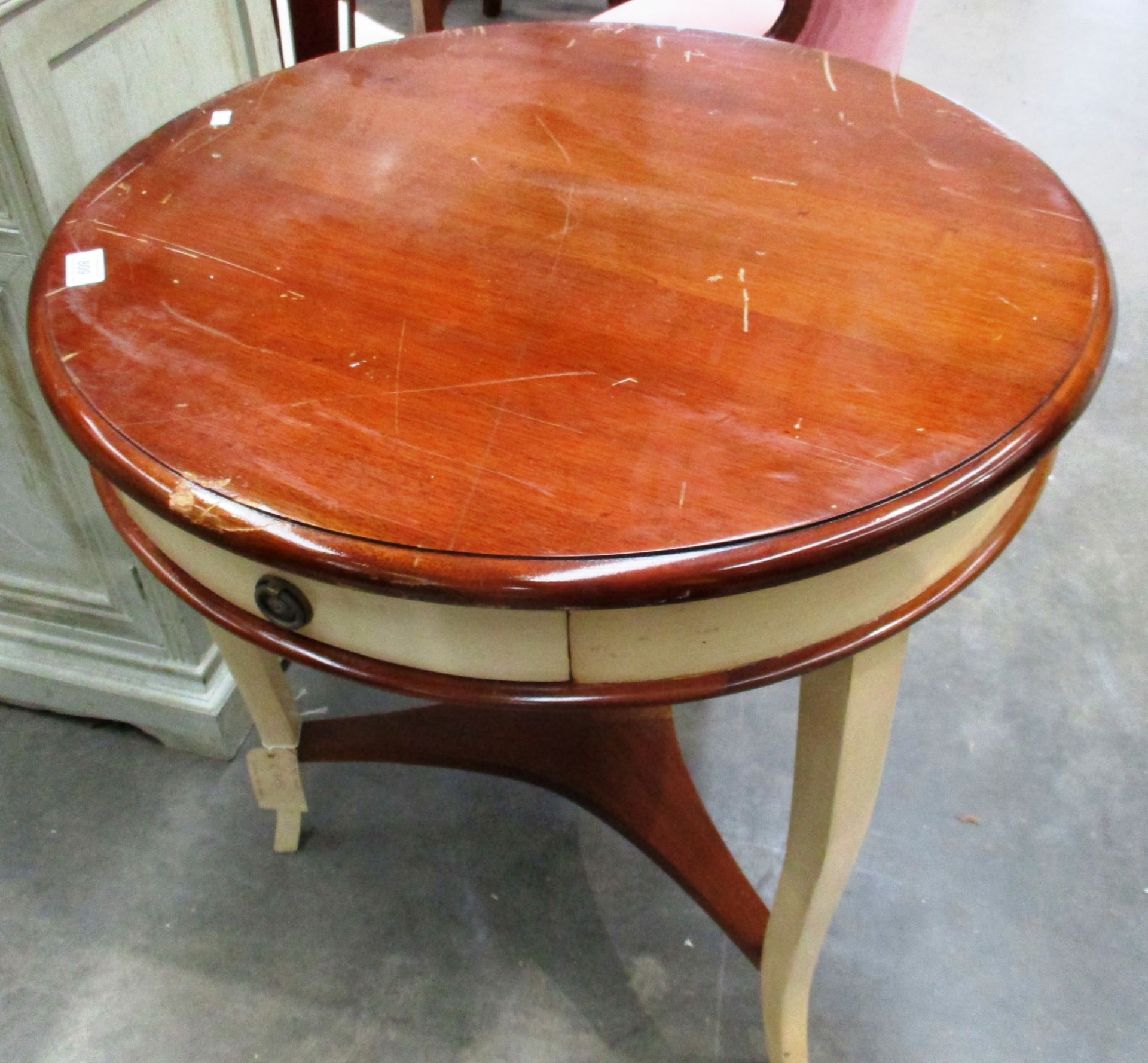 A mahogany and cream painted single drawer circular table on tripod base 68cm