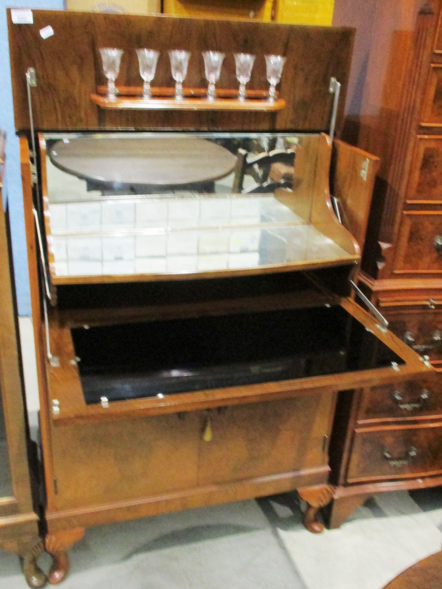 A figured walnut cocktail cabinet 76cm