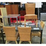 A grey metal framed glass topped dining table with under tray 150 x 80cm, 4 x wicker dining chairs,