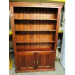 A dark stained pine 3 shelf bookcase/wall unit with 2 under doors 103 x 185cm high