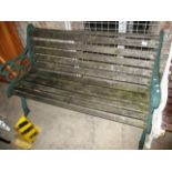 A green metal framed garden bench 130cm