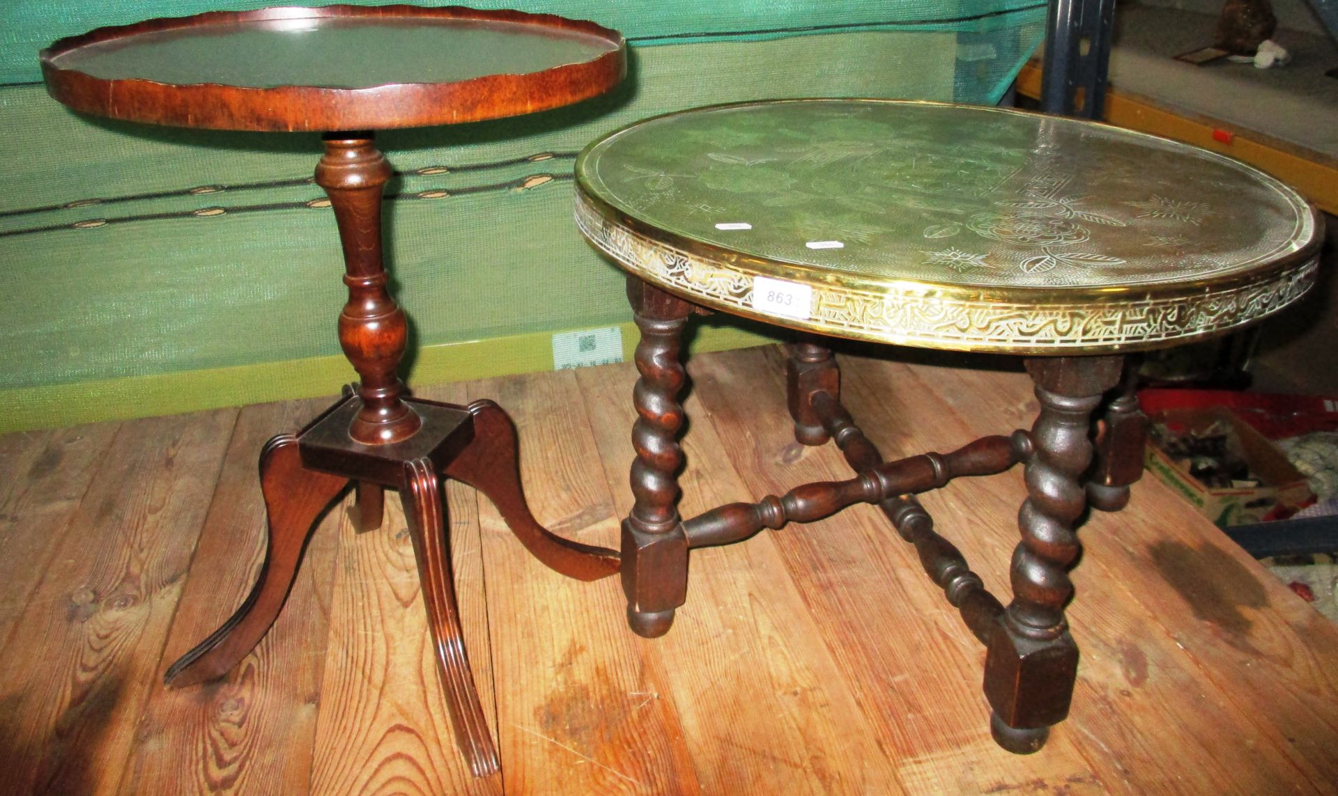 A Benares brass top table with folding base and a small mahogany oval top wine table (2)
