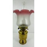 A brass oil lamp with glass shade and funnel 46cm high
