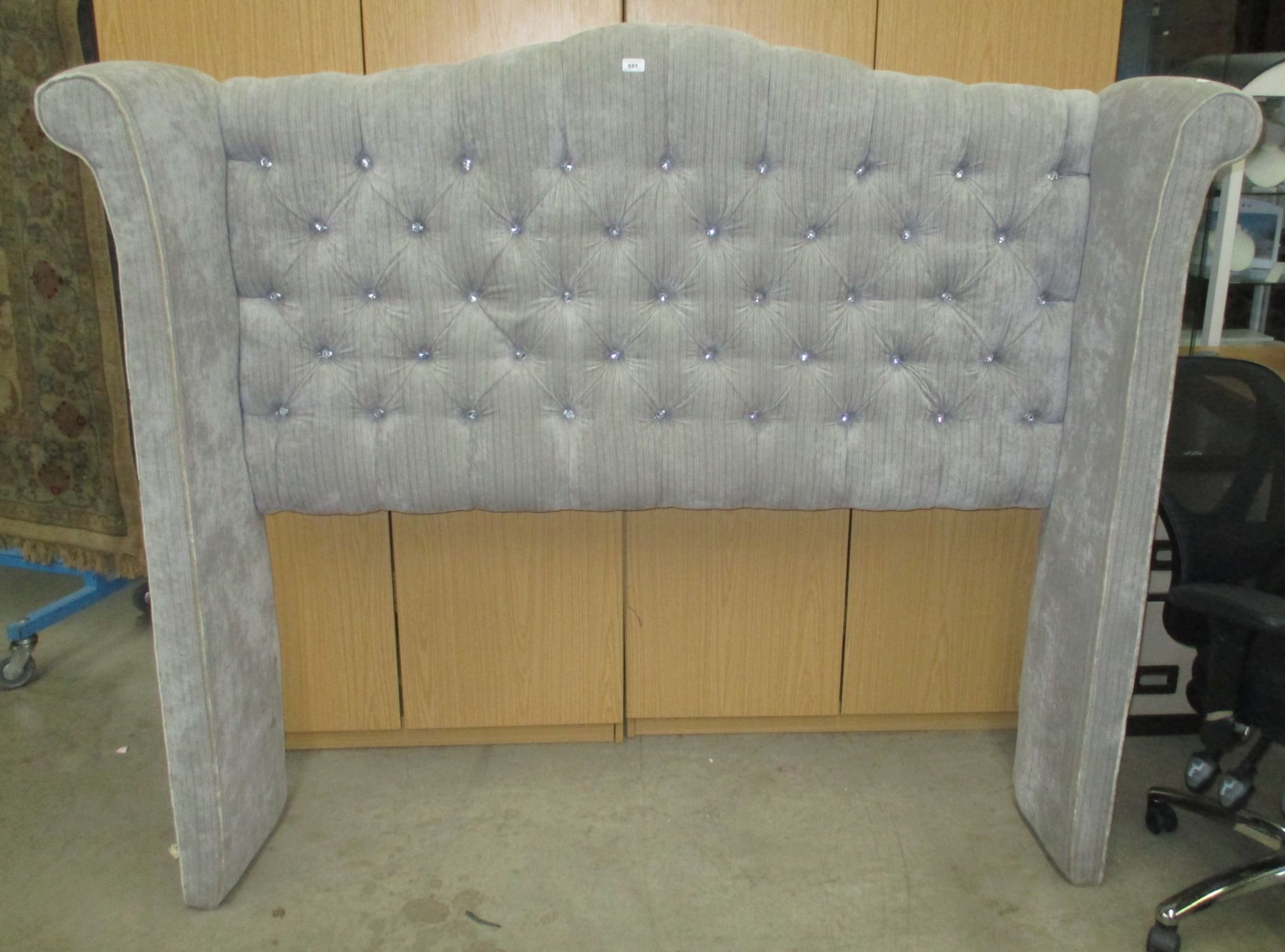 A grey deep buttoned high back 4'6" dralon headboard