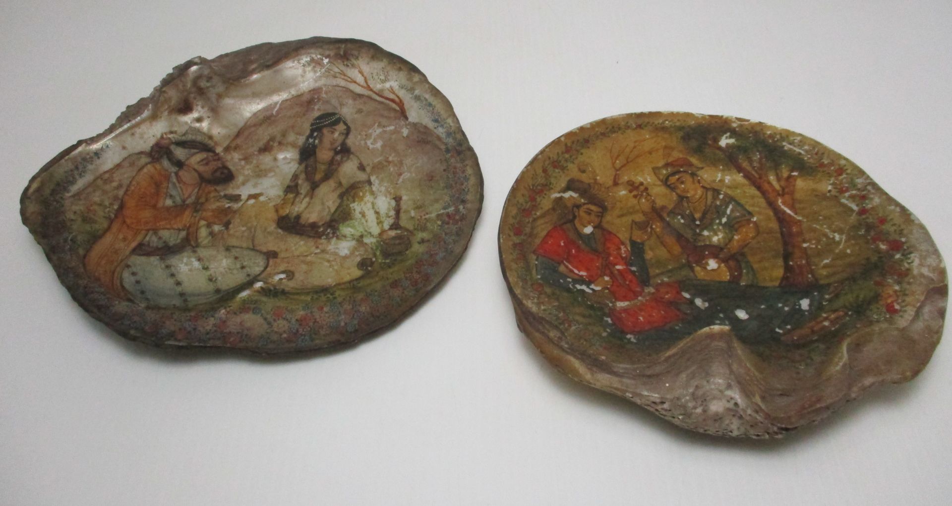 Two sea shells hand painted with Indian figures