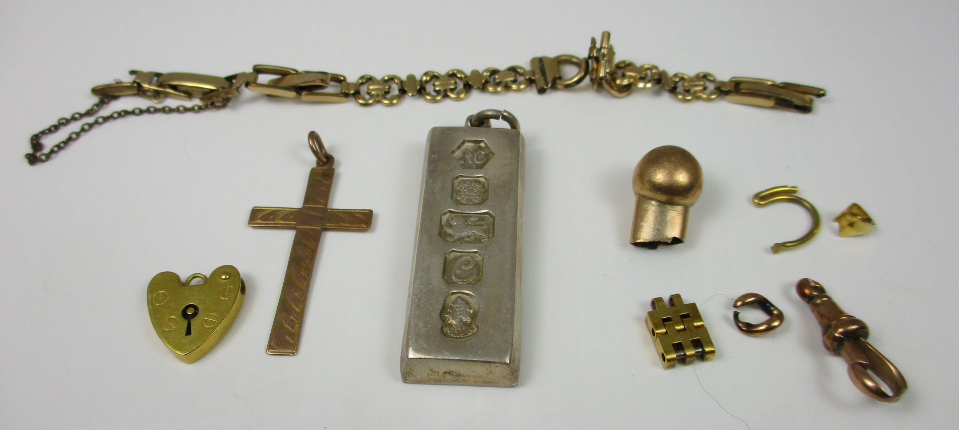 A 9ct gold padlock pendant, a 9ct gold crucifix pendant, a rolled gold watch strap,