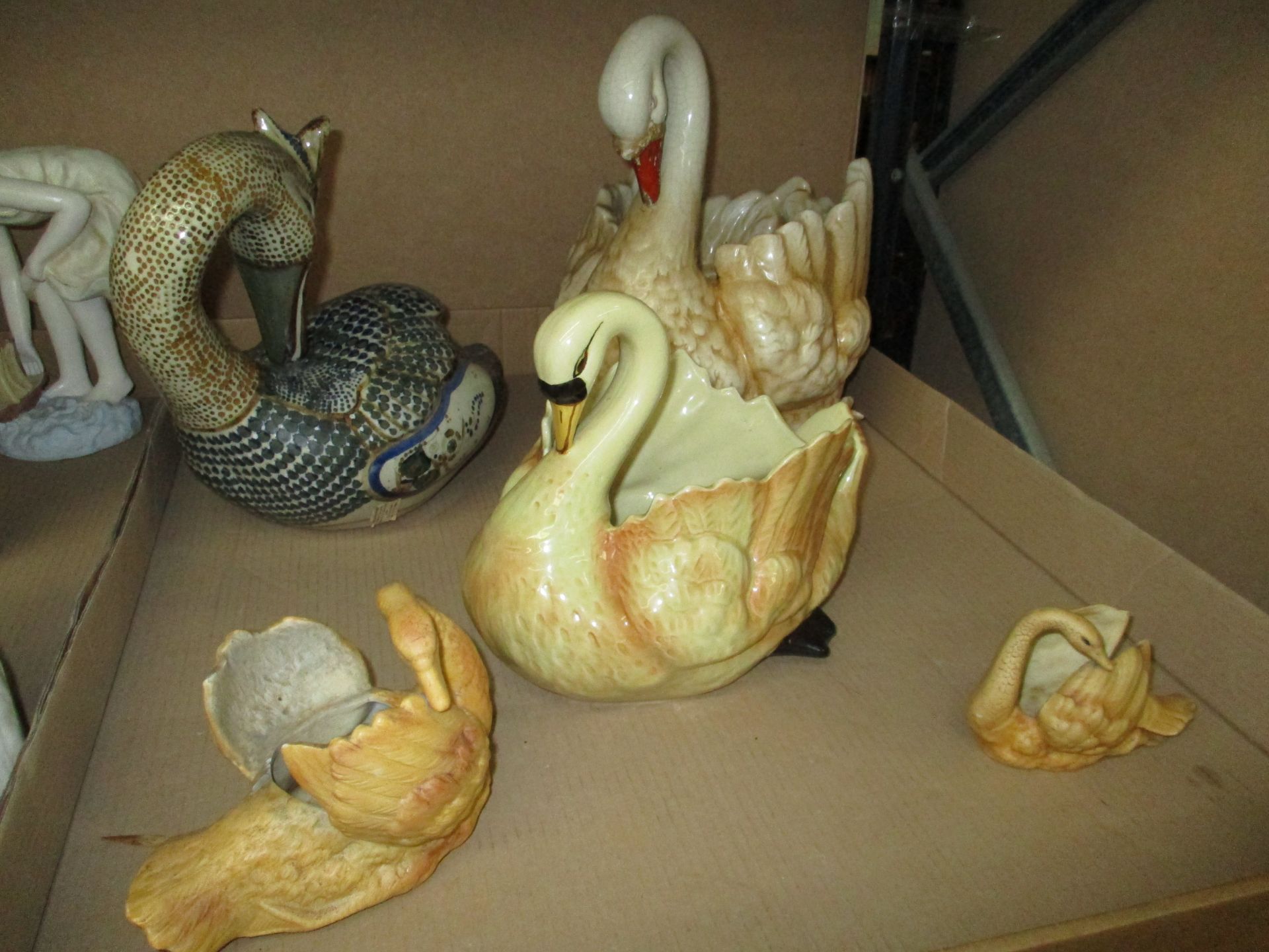 Five assorted pottery swan jardinières,