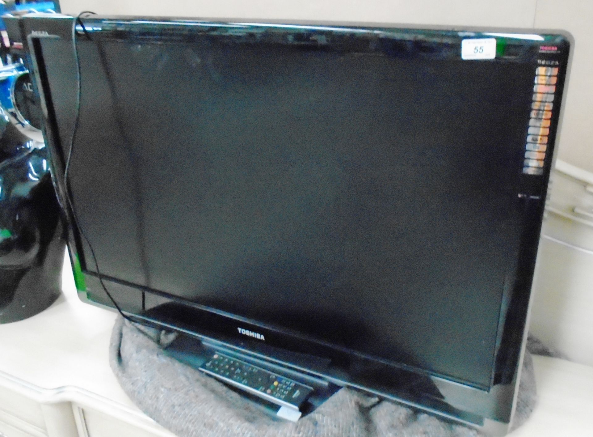 A Toshiba Regza 37XV553D 37" LCD TV with power lead and two remote controls