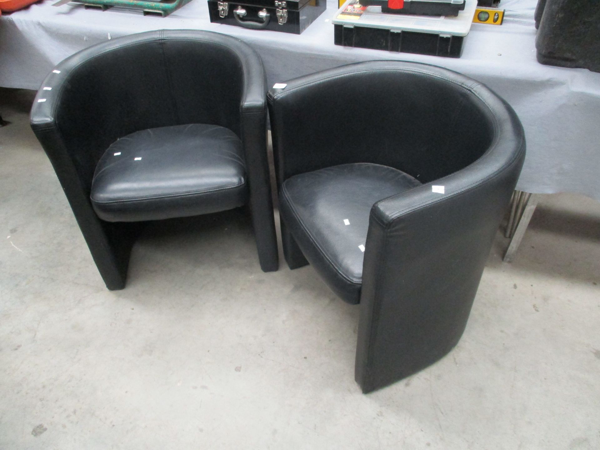 2 x black leather effect tub chairs