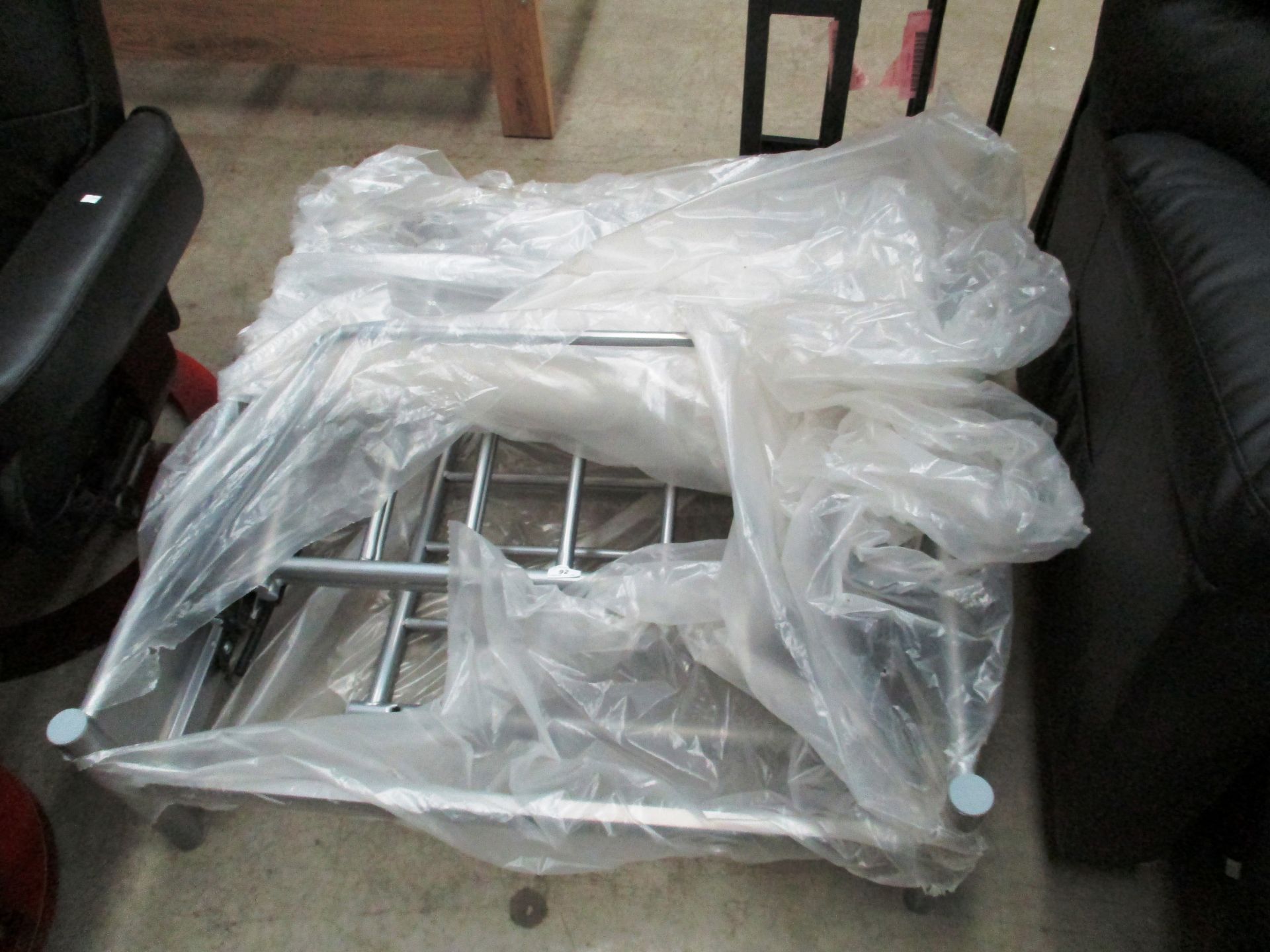 A grey metal futon bed frame