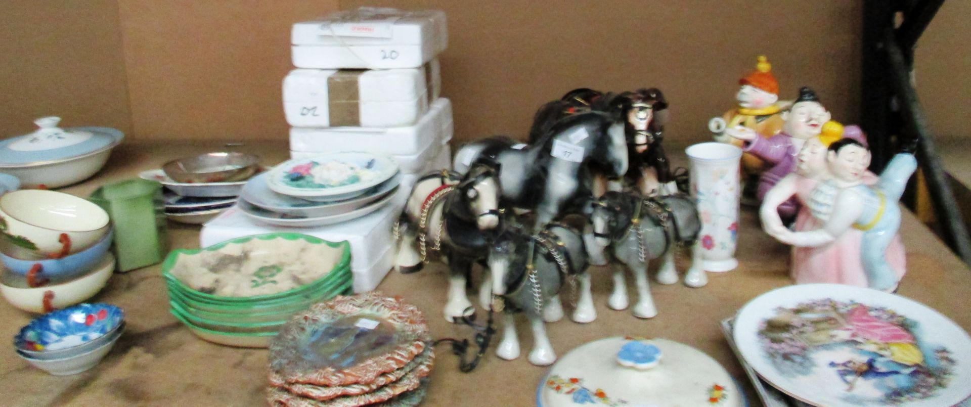 A collection of novelty teapots, pottery shire horses,