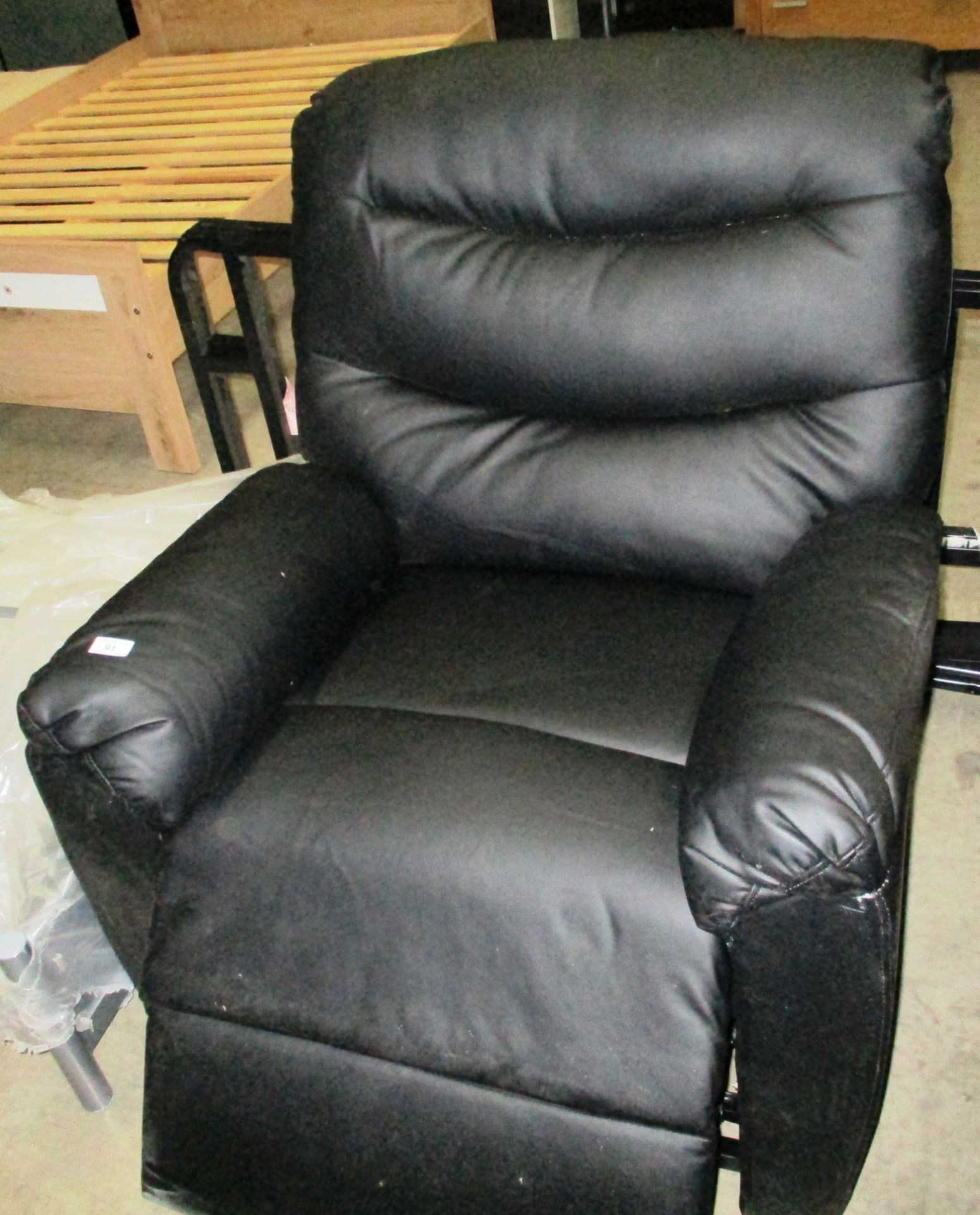 A black leatherette electric recliner chair complete with lead
