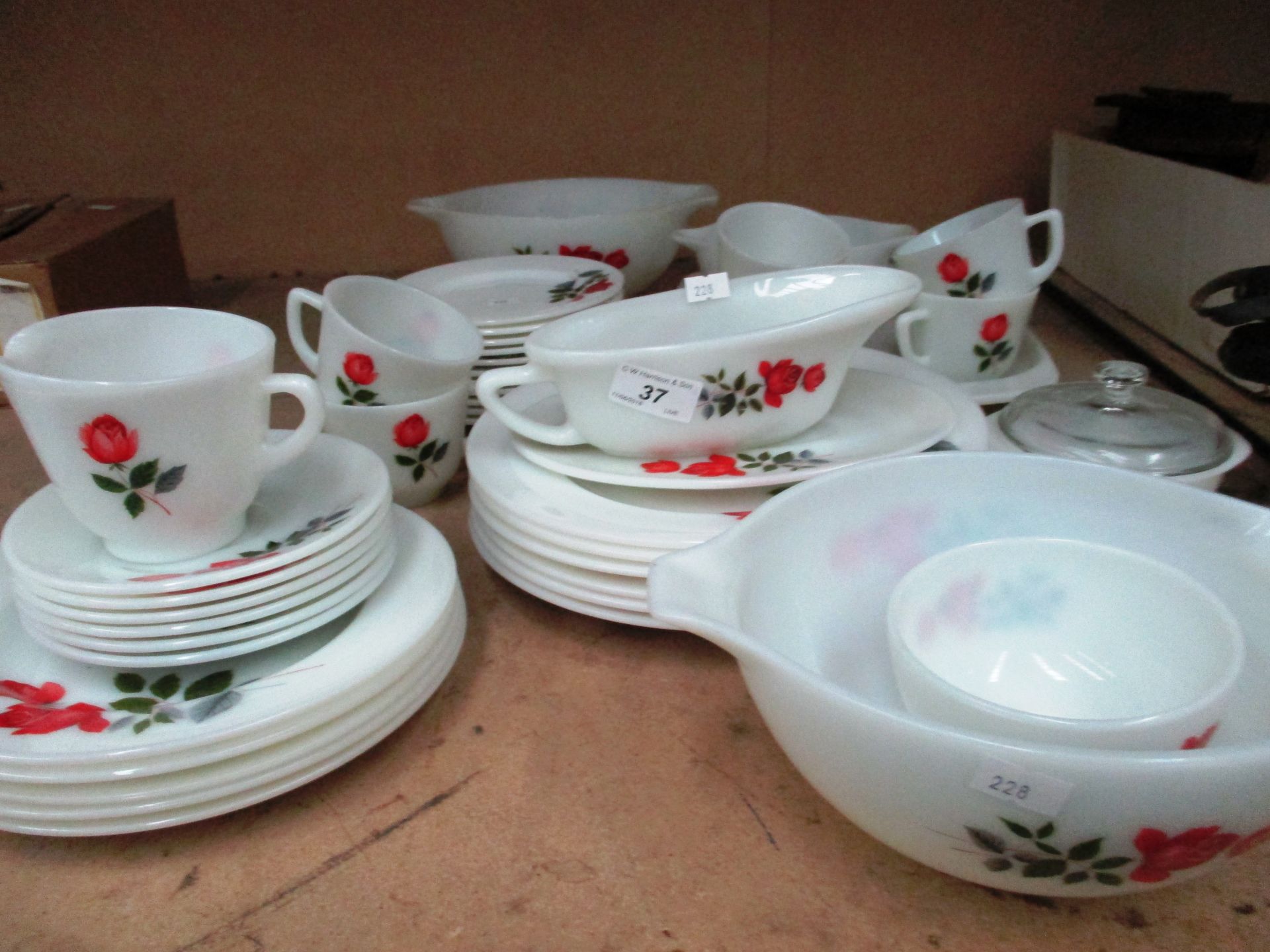 A quantity of patterned white glass tableware by Jaj