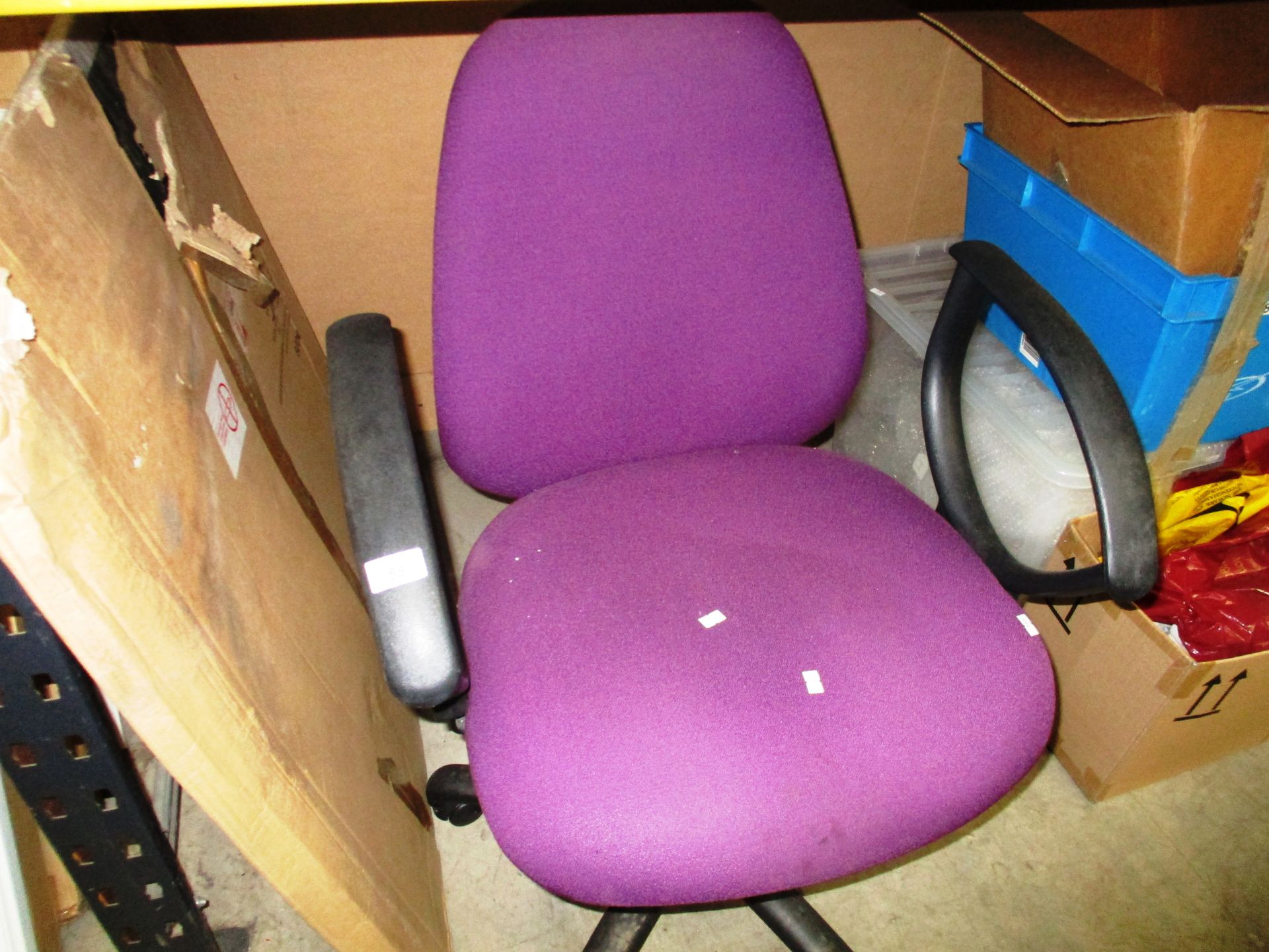 A purple cloth upholstered operators swivel armchair