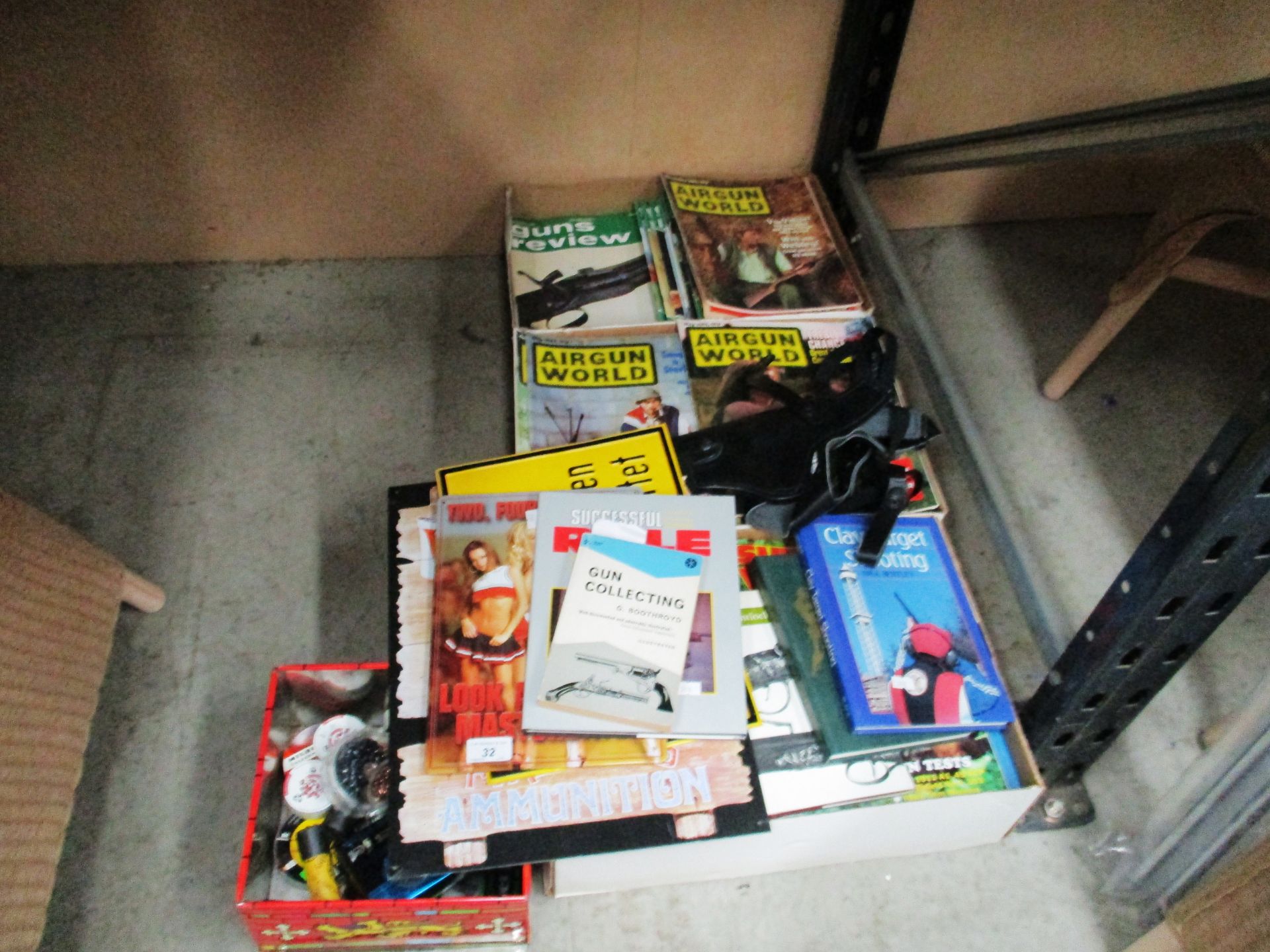 3 boxes of Airgun World and Guns review magazines and a pistol holster,