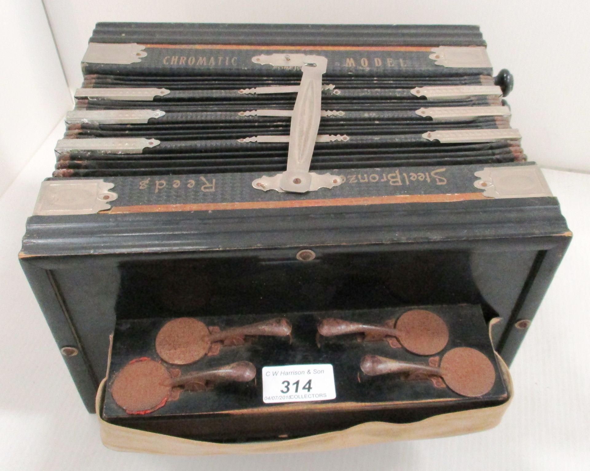 A Reeds steel bronze chromatic accordion