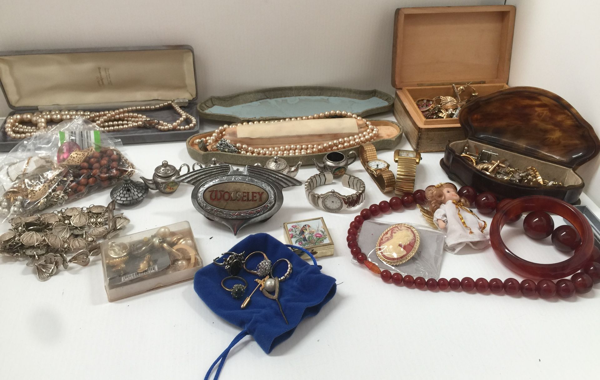Contents to box - Wolseley car badge, quantity of costume jewellery including pearl necklaces,