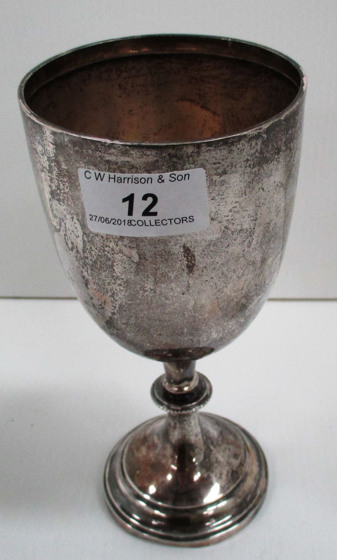 An Edwardian silver semi ovoid trophy cup on collared stem and circular foot,