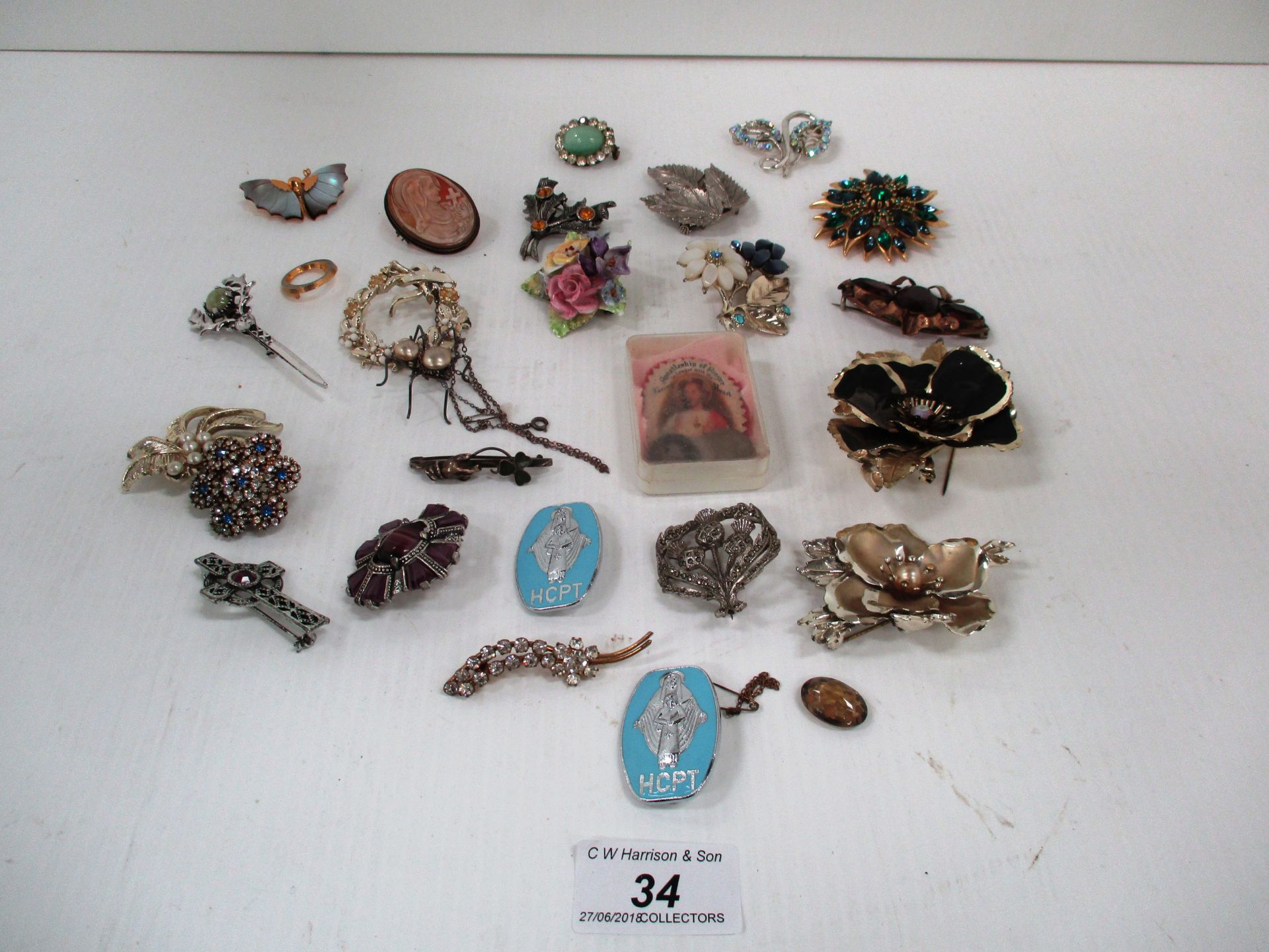 24 x brooches and four coins