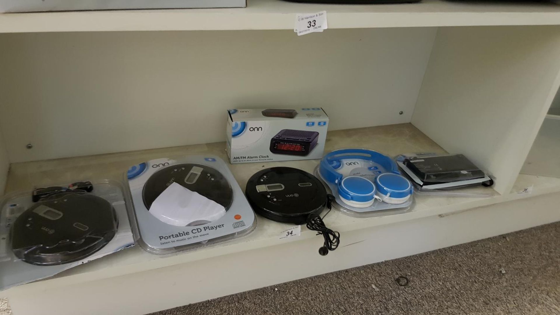 Contents of Shelf – to include (3x) Onn Portable CD Player,