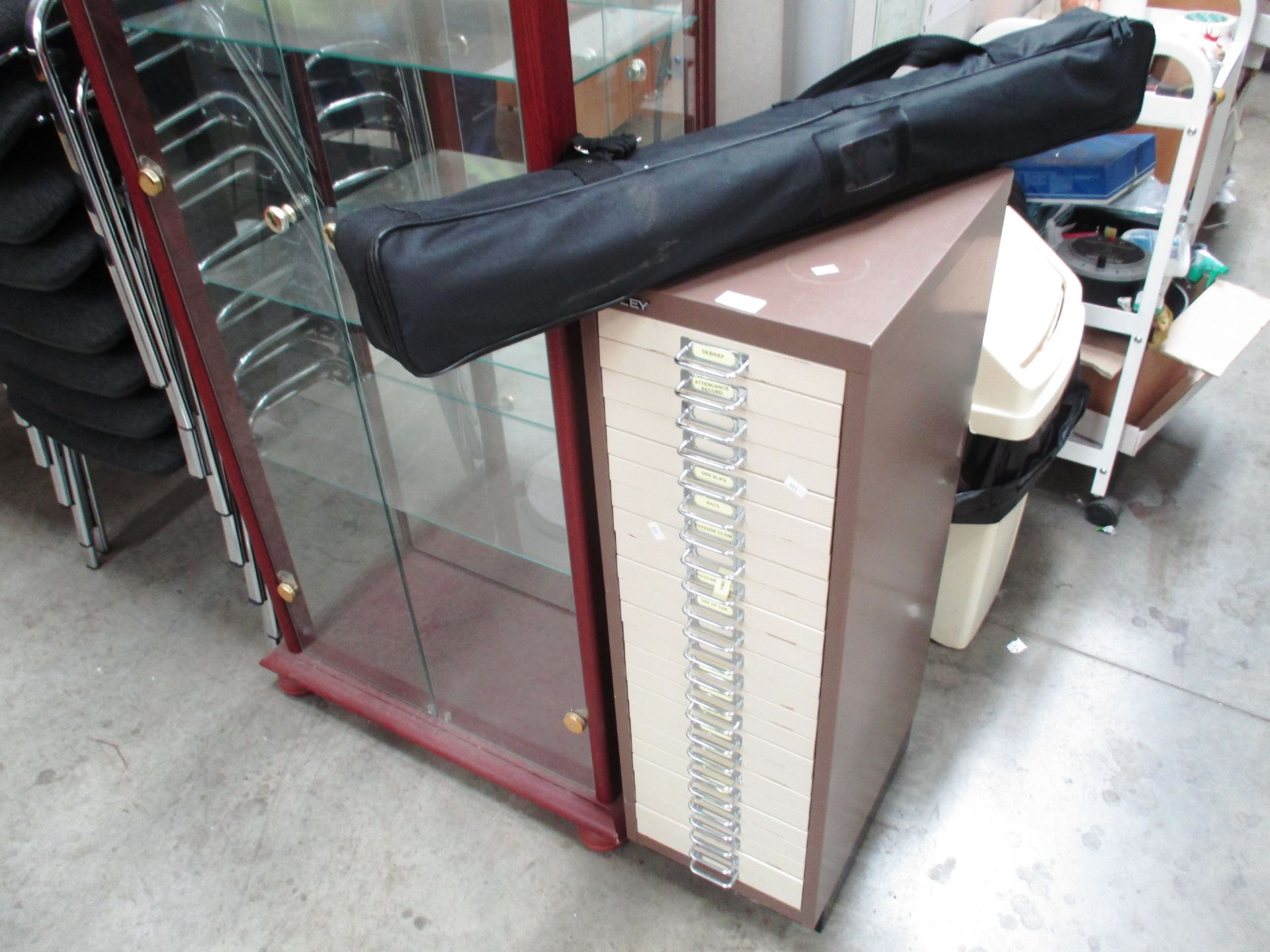 A Bisley brown and beige metal 24 drawer index cabinet and a pop up display screen