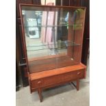 Small teak display cabinet with glazed upper section,