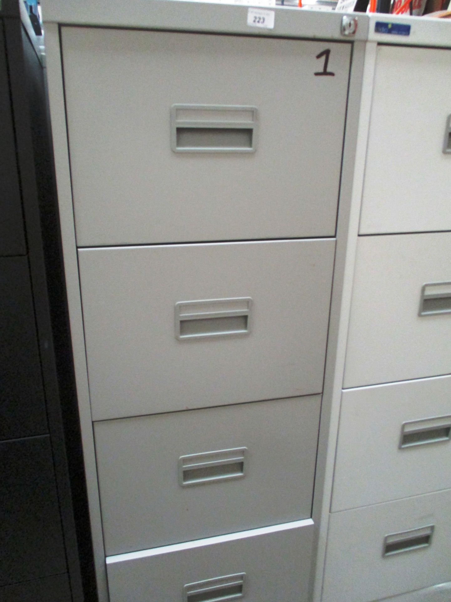 A grey metal four drawer filing cabinet (unlocked no keys)