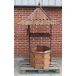 A wooden octagonal shaped ornamental wishing well with roof 190cm