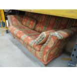 An orange and green patterned 3 seater sofa