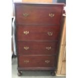 A five drawer chest of drawers with brass swing handles,