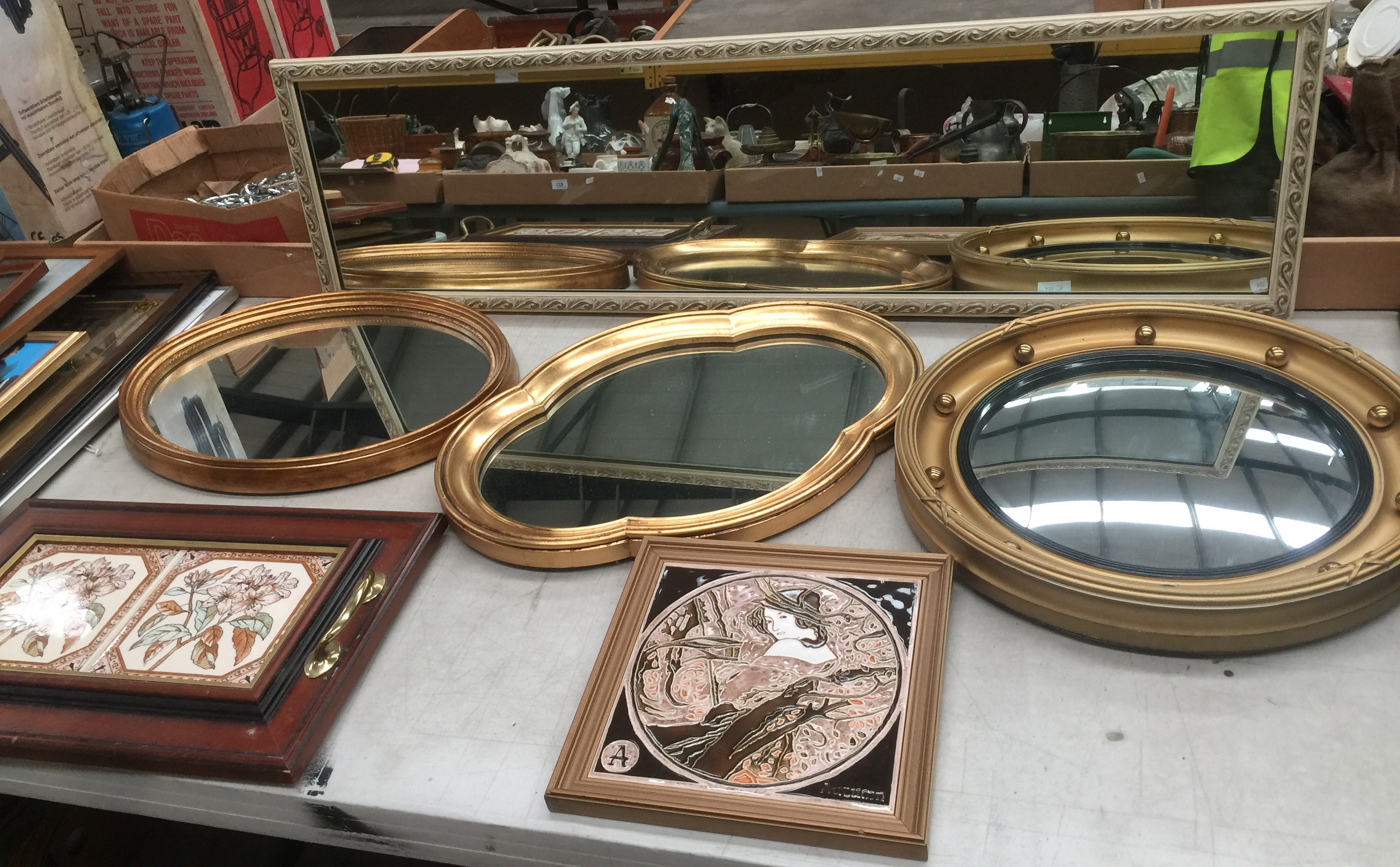 Four assorted mirrors, an Art Nouveau style tile depicting Autumn and a tile tray.