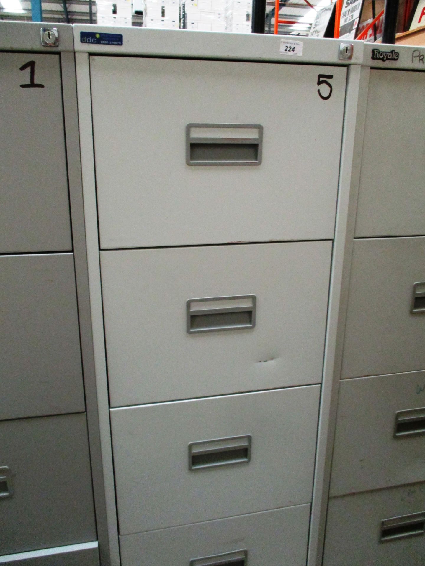 A grey metal four drawer filing cabinet (unlocked no keys)