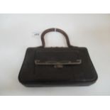 A ladies small brown leather finish clutch bag