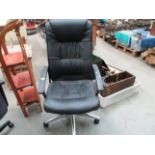 A black leather finish office high back arm chair on chrome feet