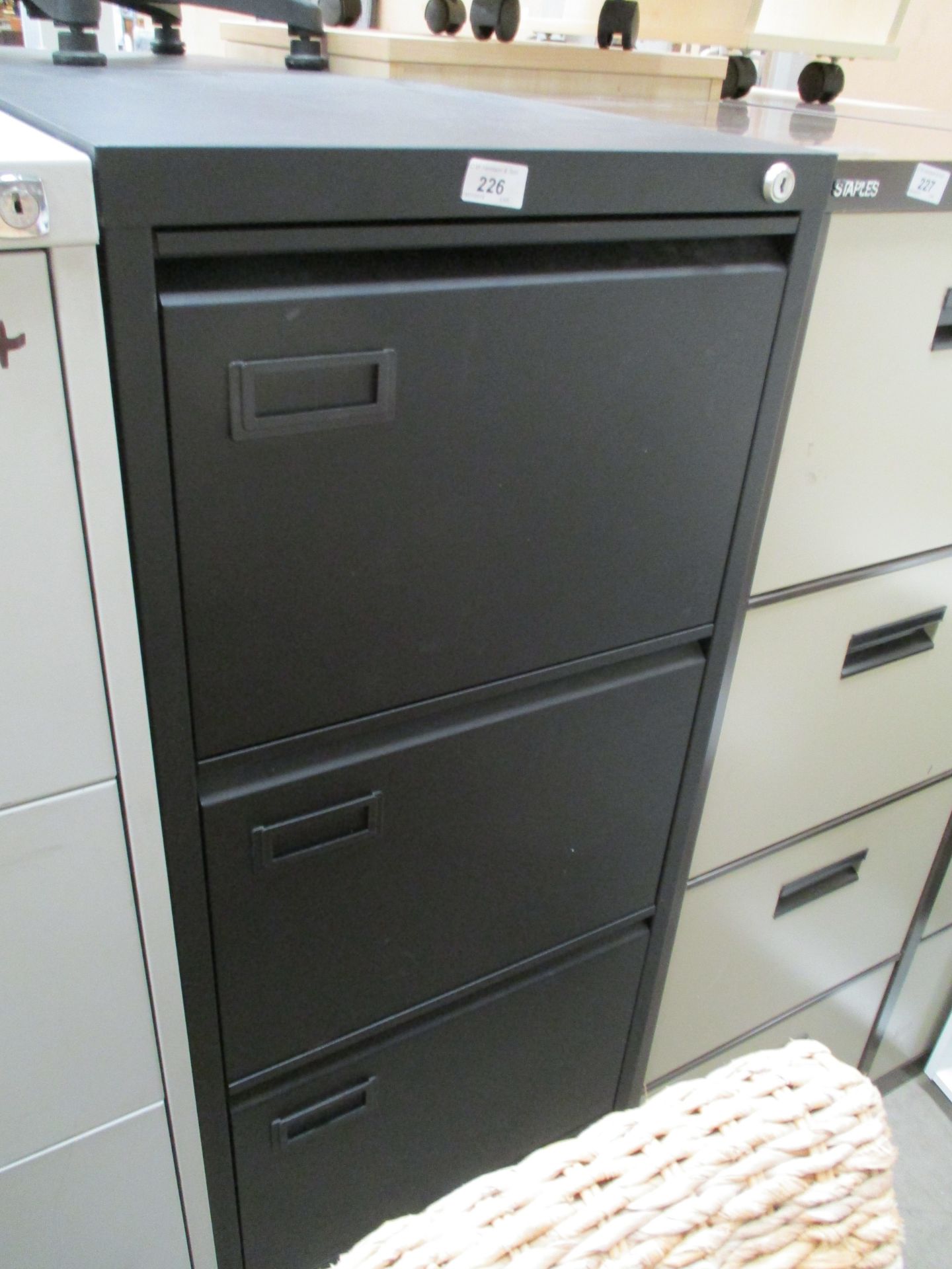 A black metal four drawer filing cabinet (unlocked no keys)